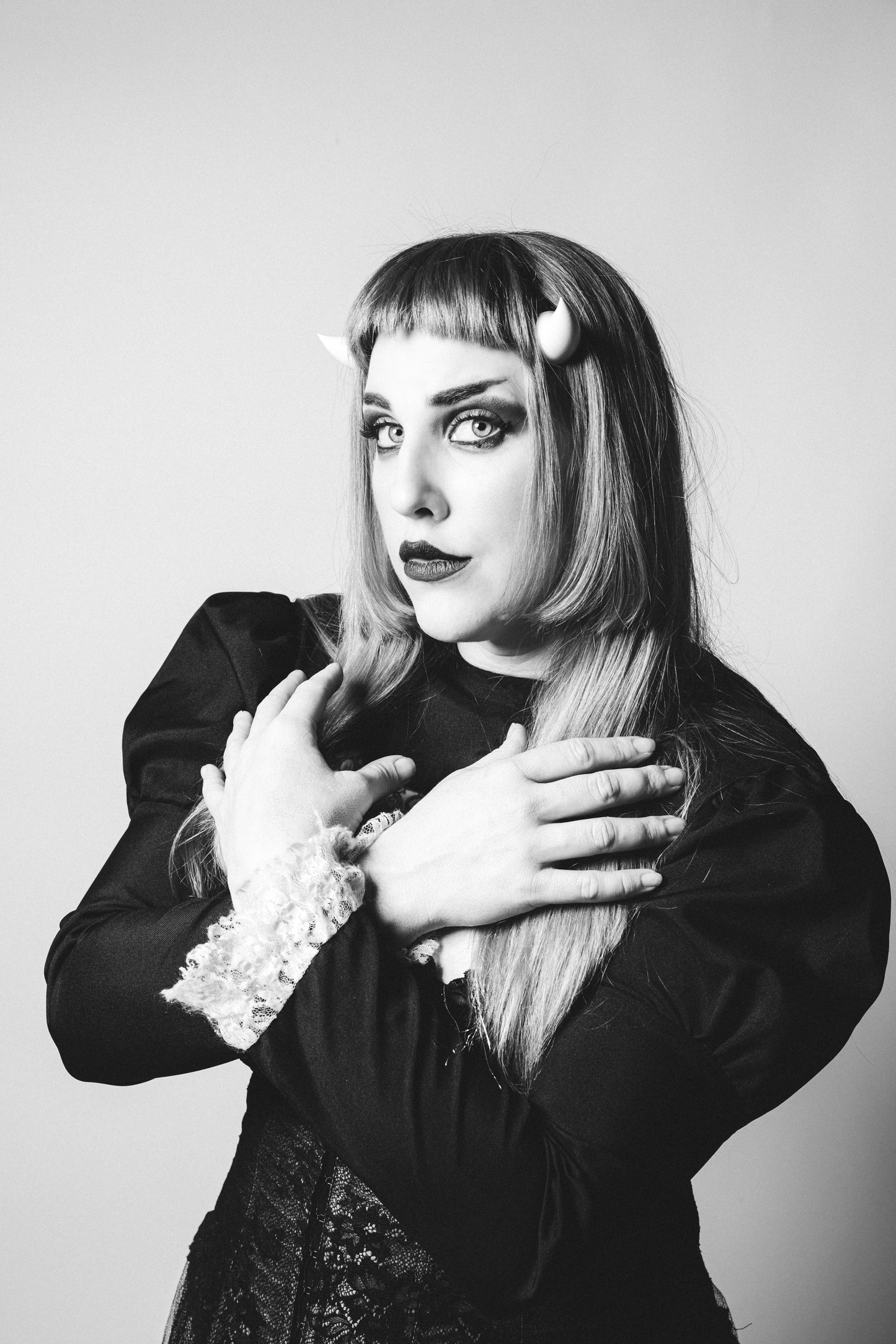 Model Stormy September poses in gothic attire wearing white imp horns under her bangs. Photo by Matt Stone.