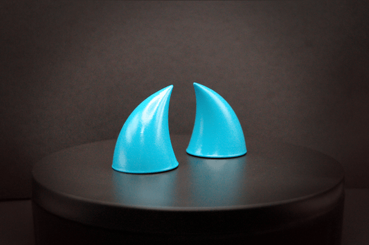 Side view of imp devil horns in naiad blue, a cyan color with a glossy finish.