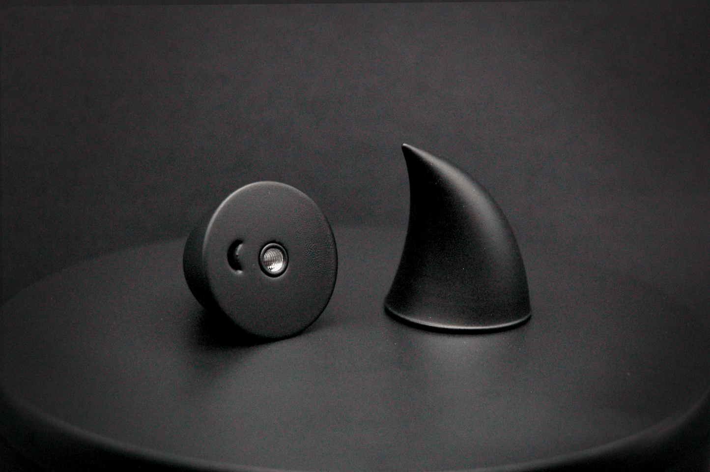 Bottom view of imp devil horns in black with a matte finish, showing a threaded insert on the base.