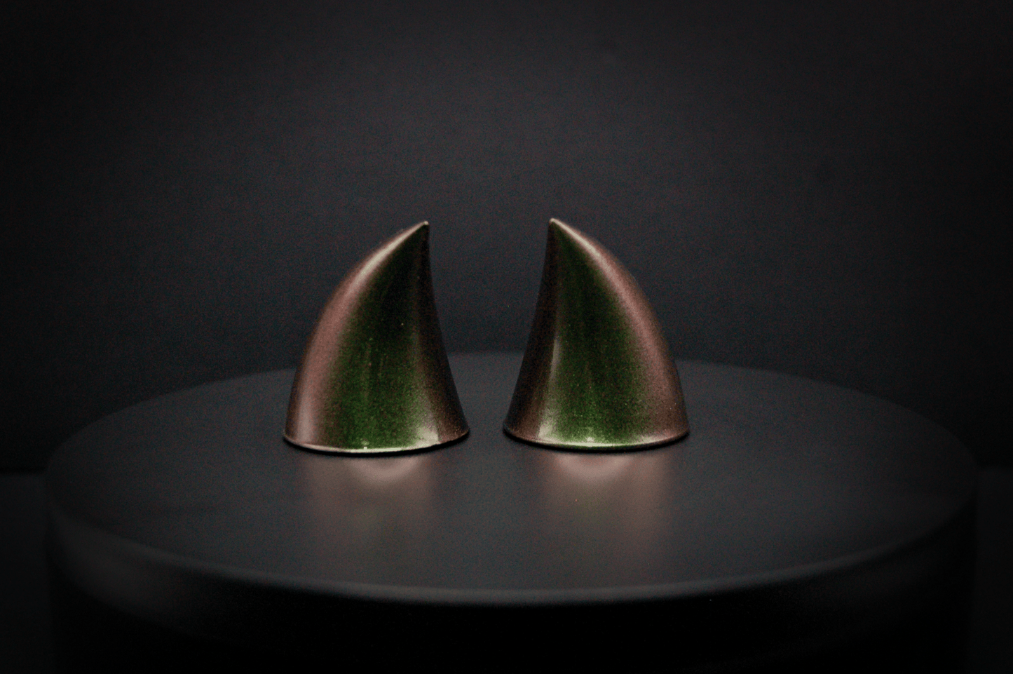 Back view of imp devil horns in metallic coppery green.