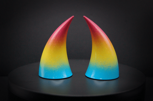 Back view of imp devil horns in a sky blue, to bright yellow, to warm pink ombré, the colors of the pansexual pride flag with a glittery finish.