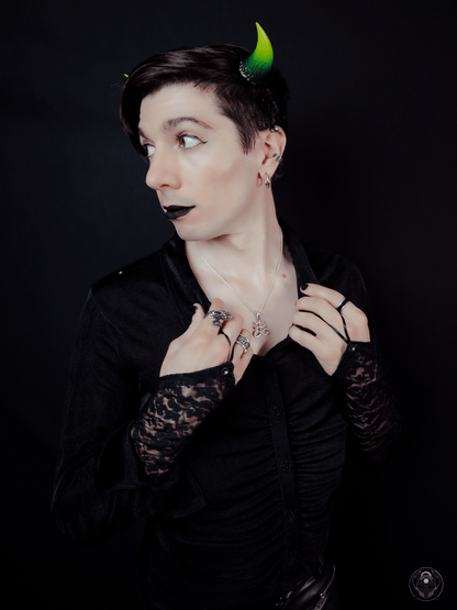 ExHeal wears a black outfit with lace sleeves and Fiend Horns in Eldritch Ombré. Photo by Synthetic Studio.