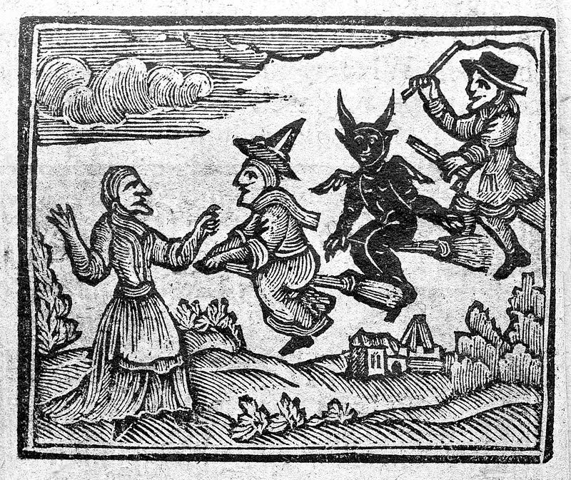 Woodcut print of witches and a devil on brooms approaching a woman with a village in the background.