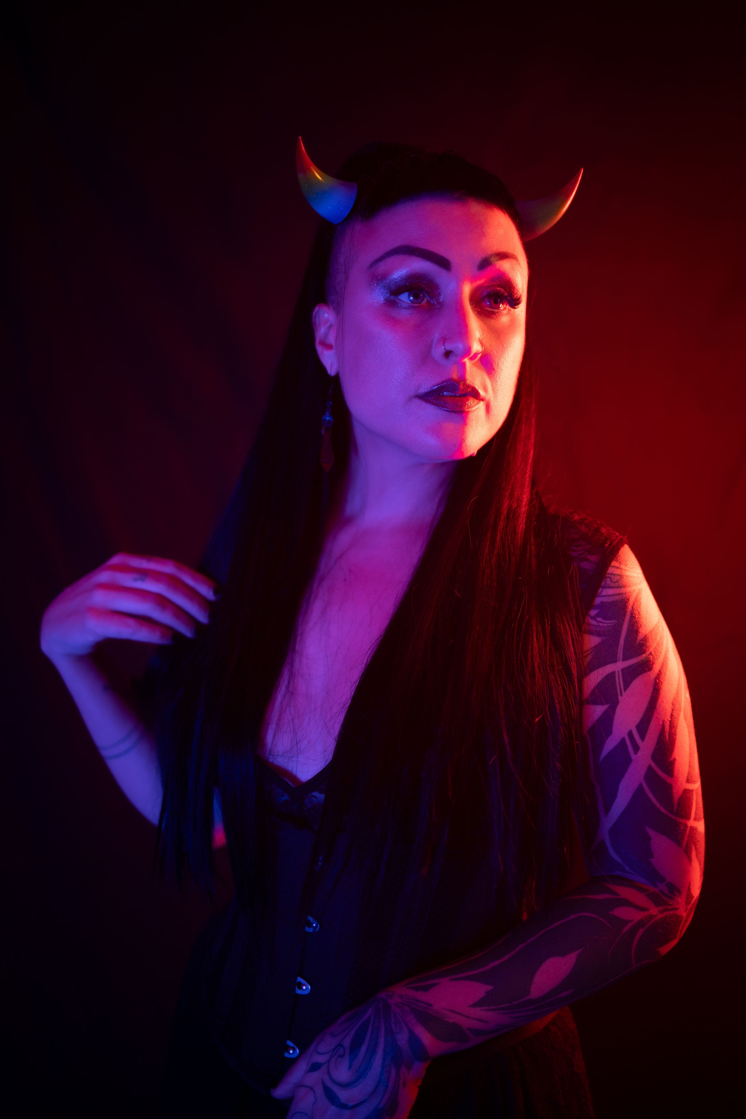 Zoe Sol models Haus of Brimstone Incubus Horns in Rainbow Pride in a photo by Optic Onslaught. 