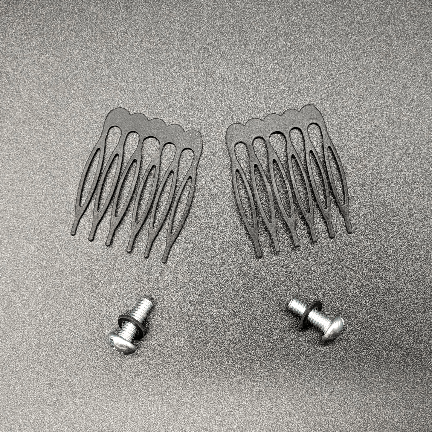 Two catacomb hair combs and two screws with silicone washers.