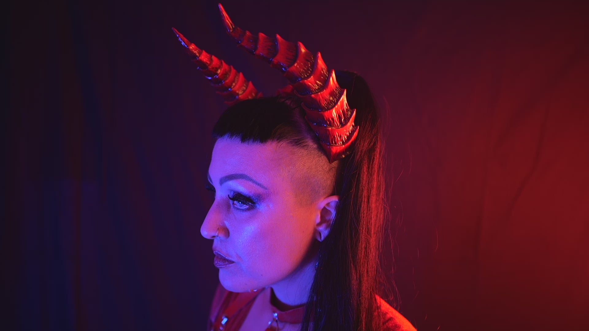 Load video: Zoe Sol models Haus of Brimstone Tiefling Horns in a video by Optic Onslaught. 