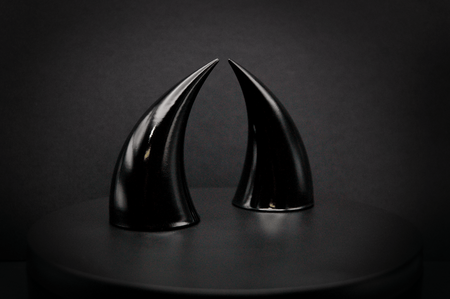 Side view of incubus devil horns in black with a glossy finish.