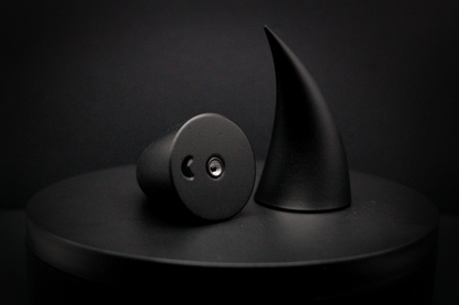 Bottom view of incubus devil horns in black with a matte finish, showing a threaded insert on the base.