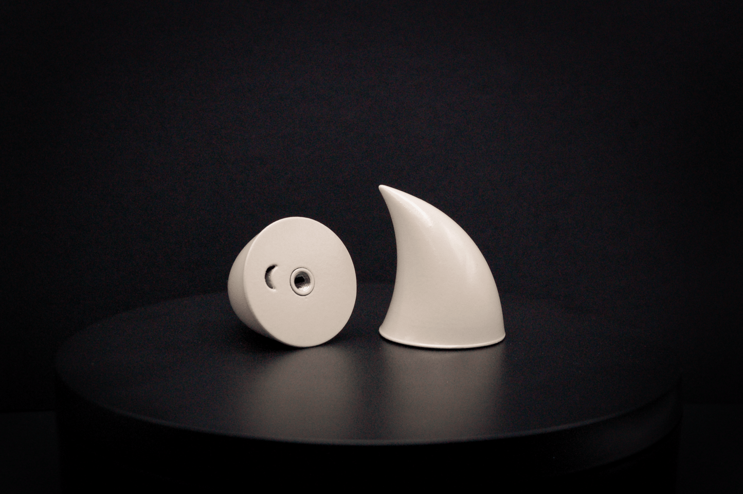 Bottom view of imp devil horns in bone white with a glossy finish, showing a threaded insert on the base.
