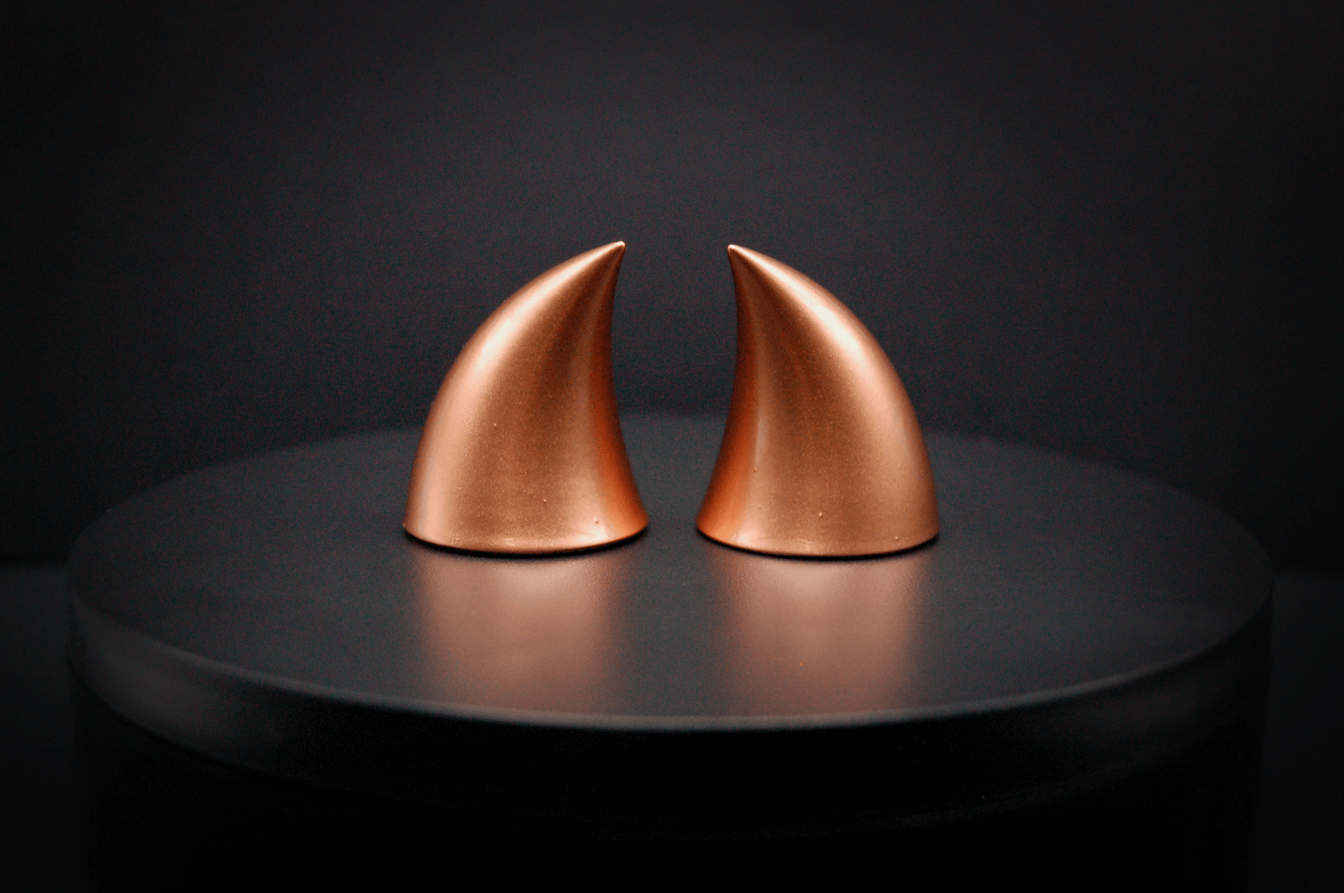 Back view of imp devil horns in metallic copper.