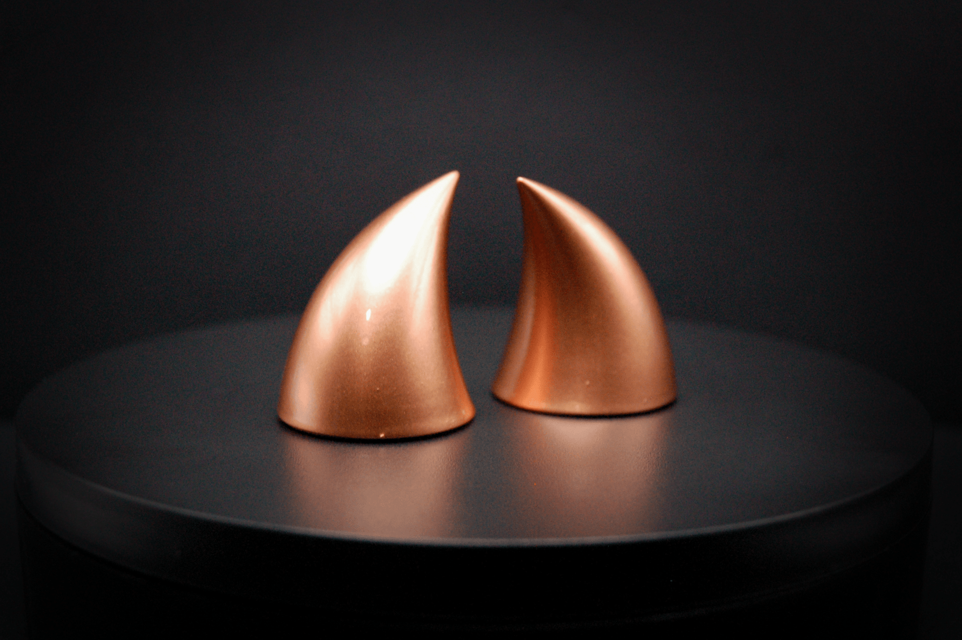 Side view of imp devil horns in metallic copper.