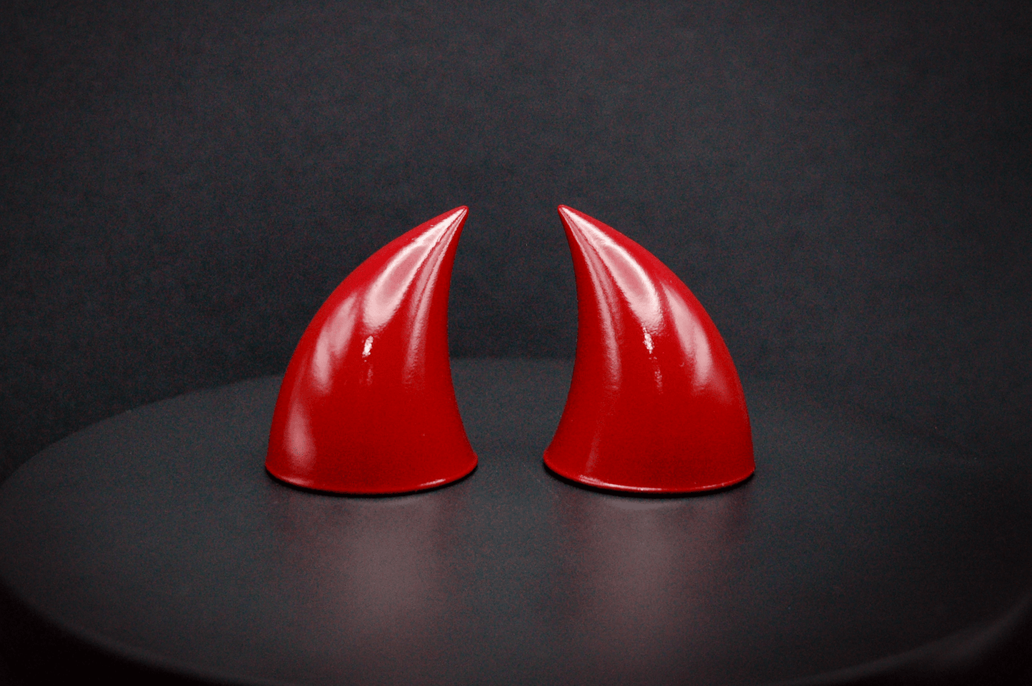 Front view of imp devil horns in bordeaux red with a glossy finish.