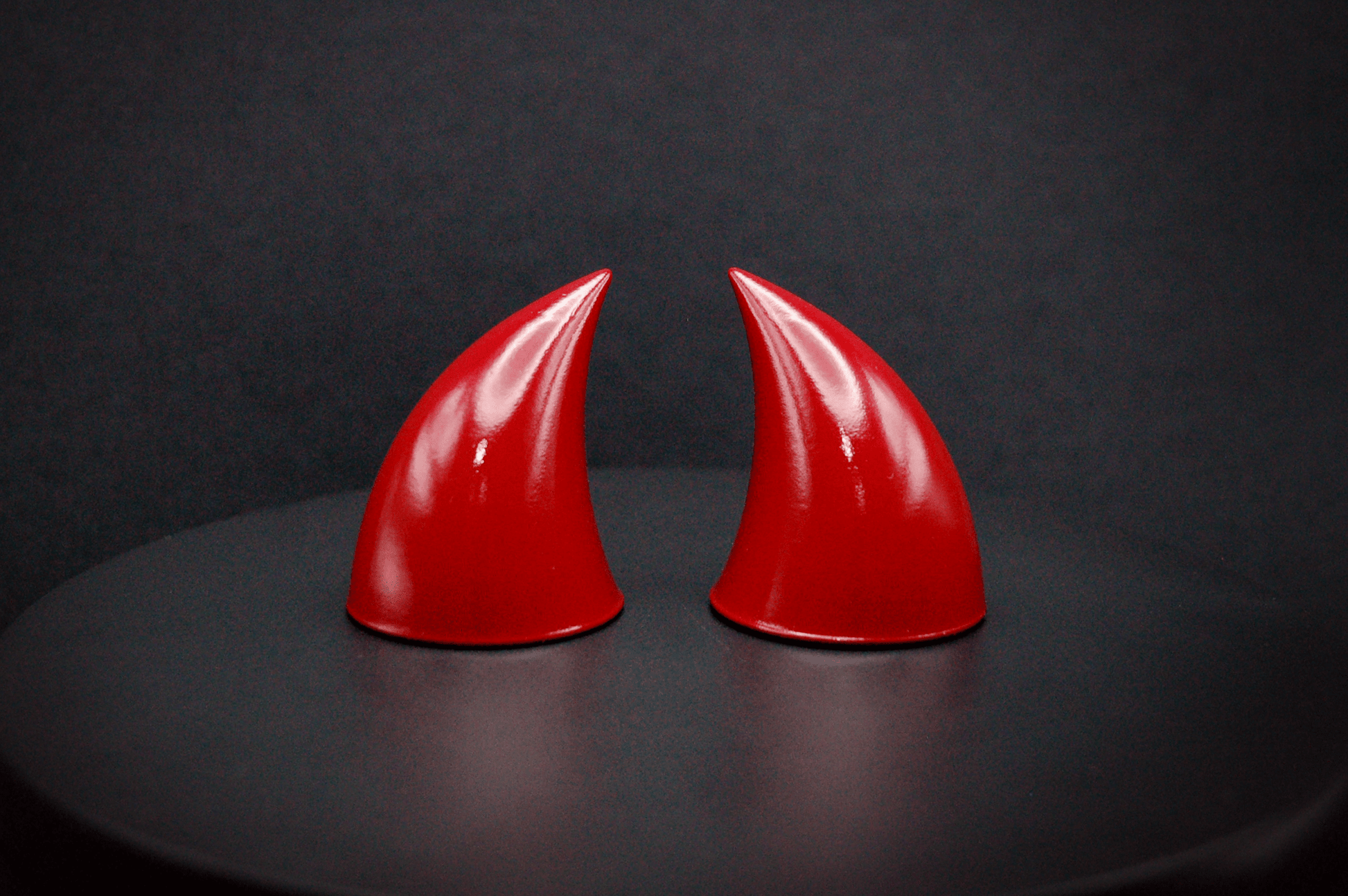 Front view of imp devil horns in bordeaux red with a glossy finish.