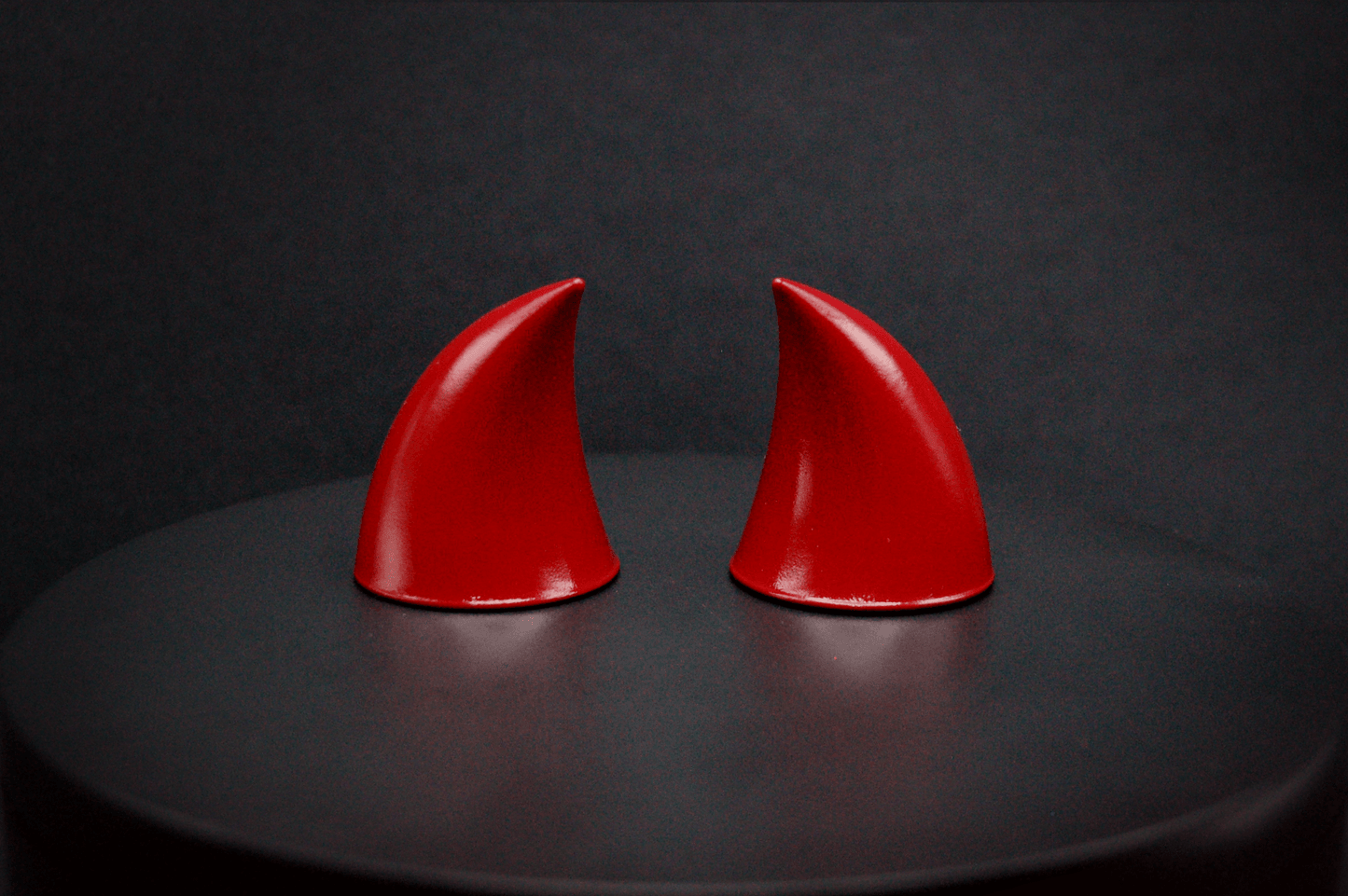 Back view of imp devil horns in  bordeaux red with a glossy finish.