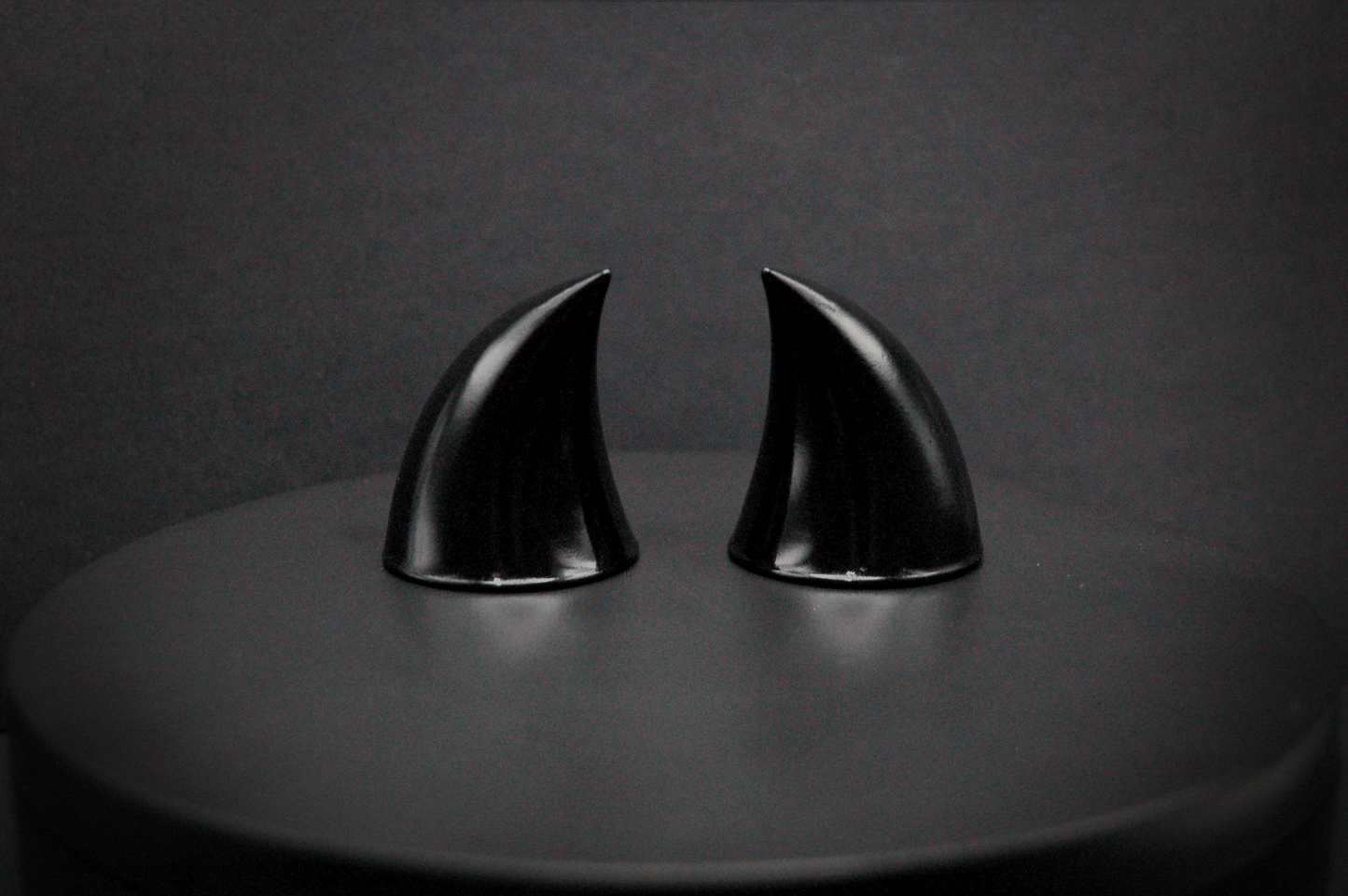 Back view of imp devil horns in black with a glossy finish.