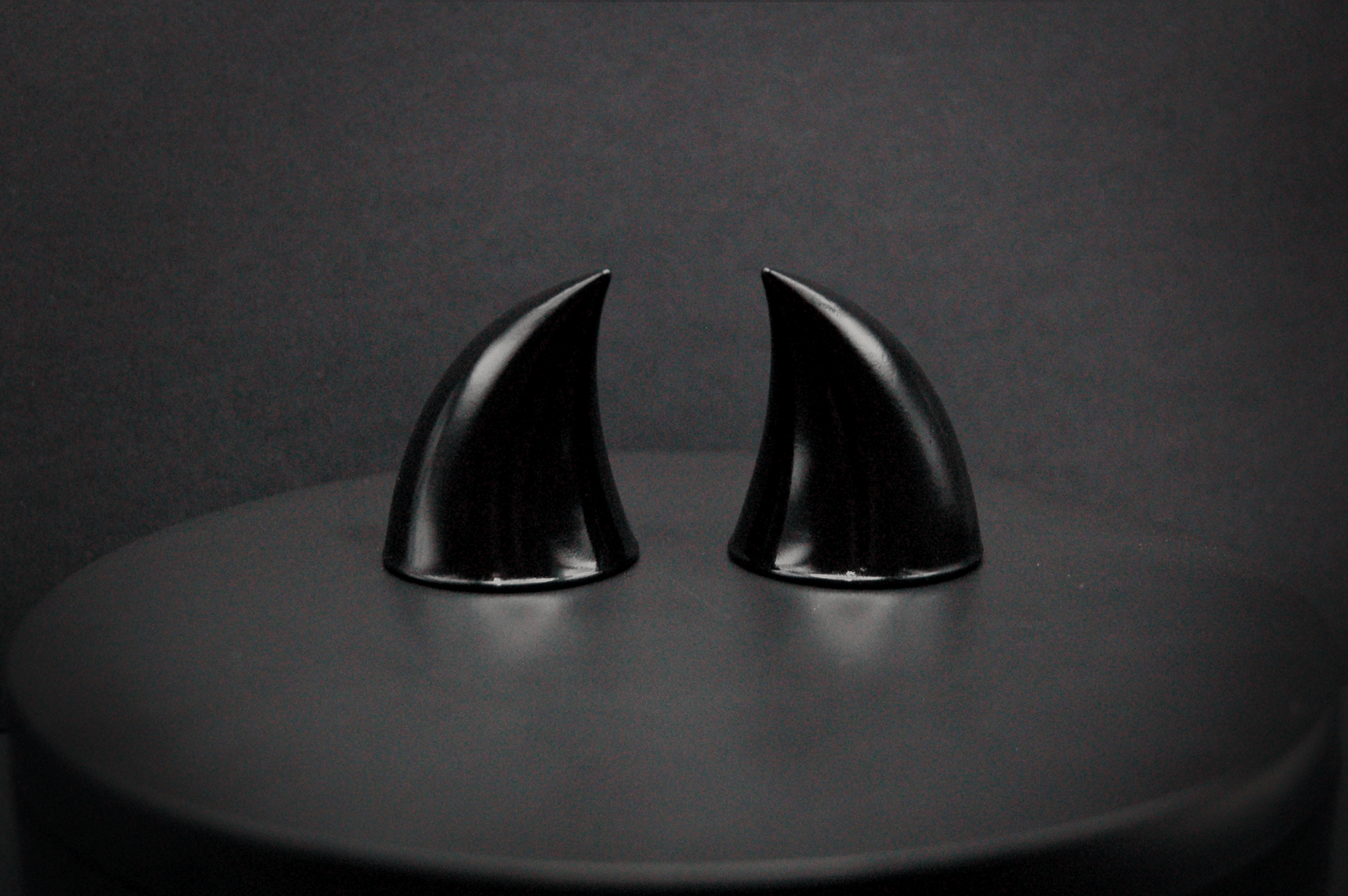 Back view of imp devil horns in black with a glossy finish.