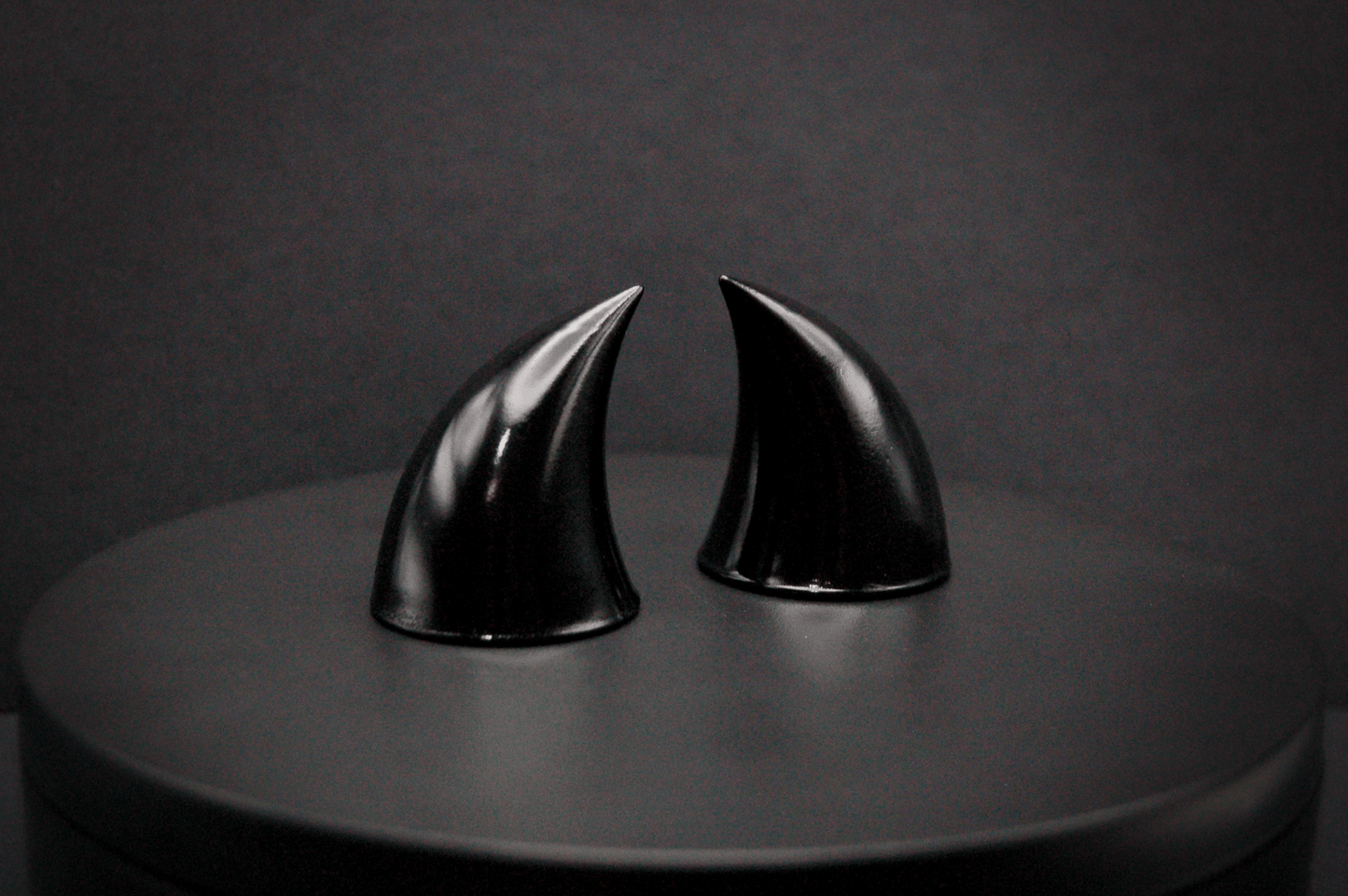 Side view of imp devil horns in black with a glossy finish.