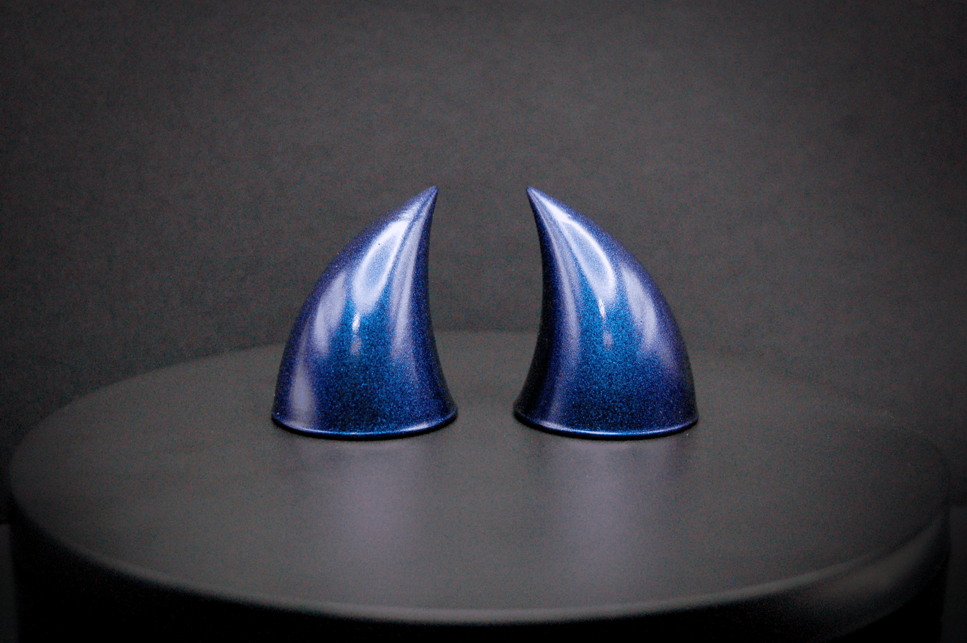 Front view of imp devil horns in metallic violet-blue.
