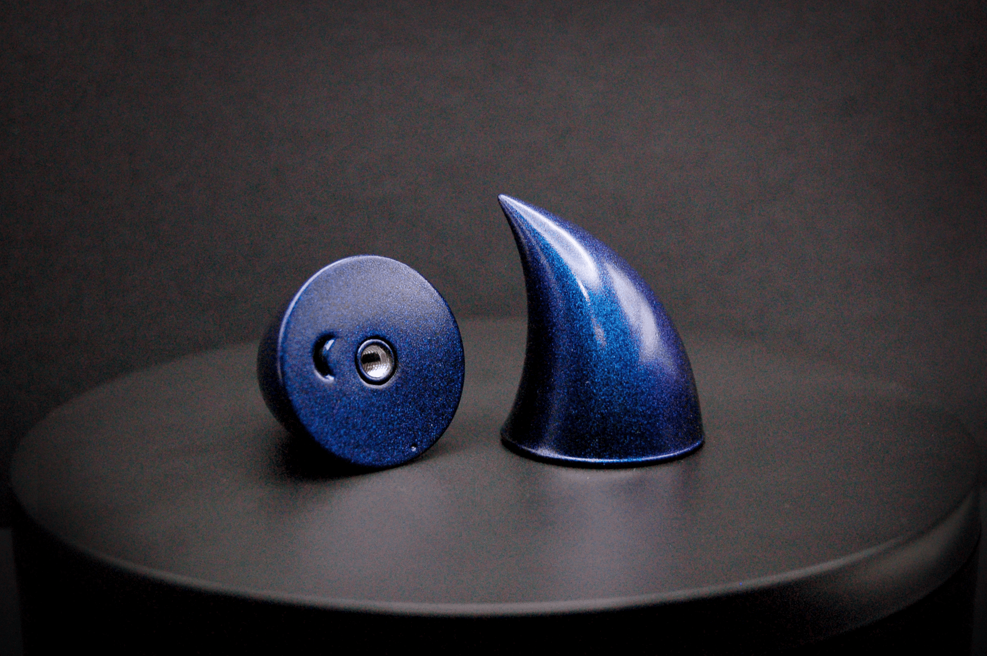 Bottom view of imp devil horns in metallic violet-blue, showing a threaded insert on the base.