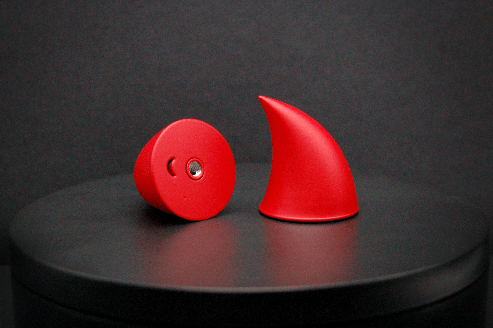 Bottom view of imp devil horns in scarlet red with a matte finish, showing a threaded insert on the base.