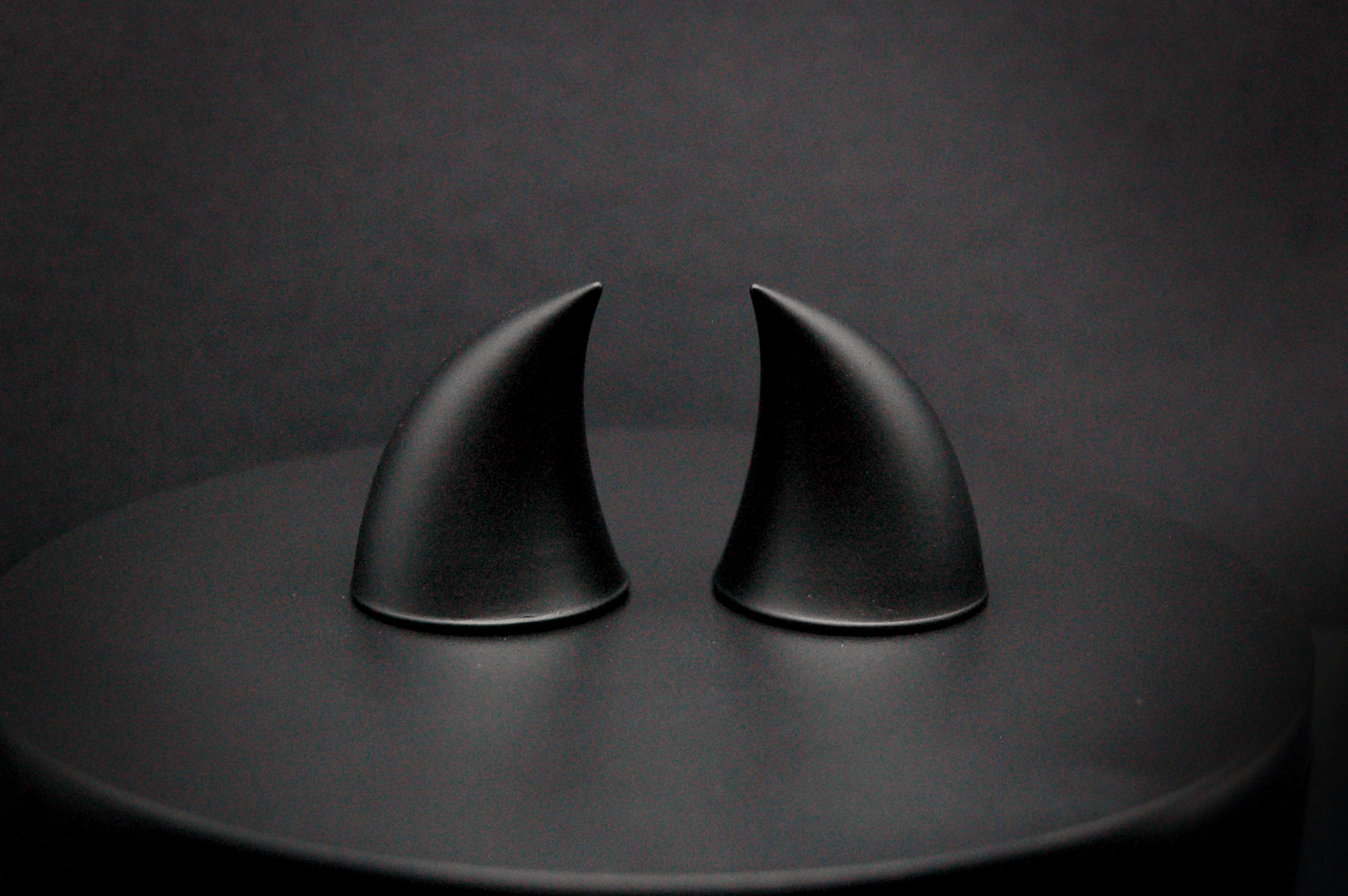 Back view of imp devil horns in black with a matte finish.