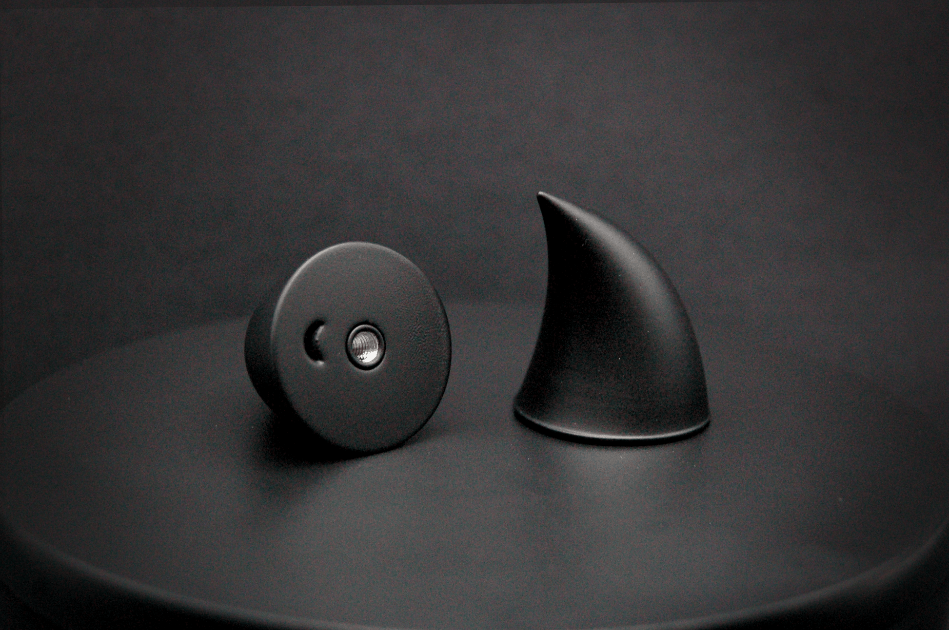Bottom view of imp devil horns in black with a matte finish, showing a threaded insert on the base.