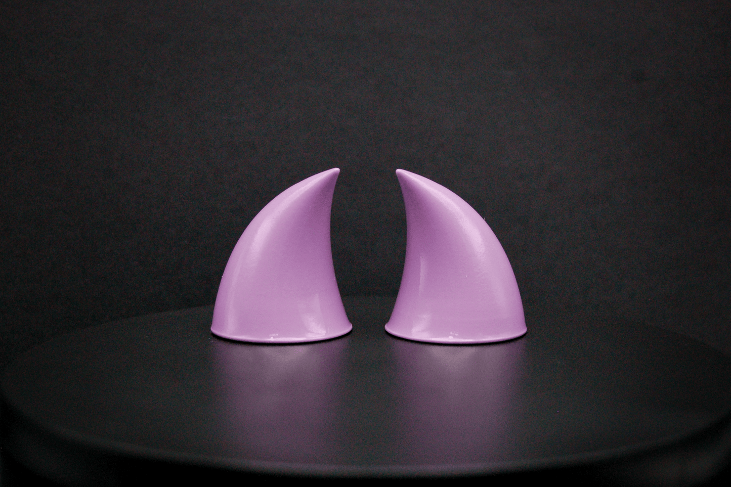 Back view of imp devil horns in lilac with a glossy finish.