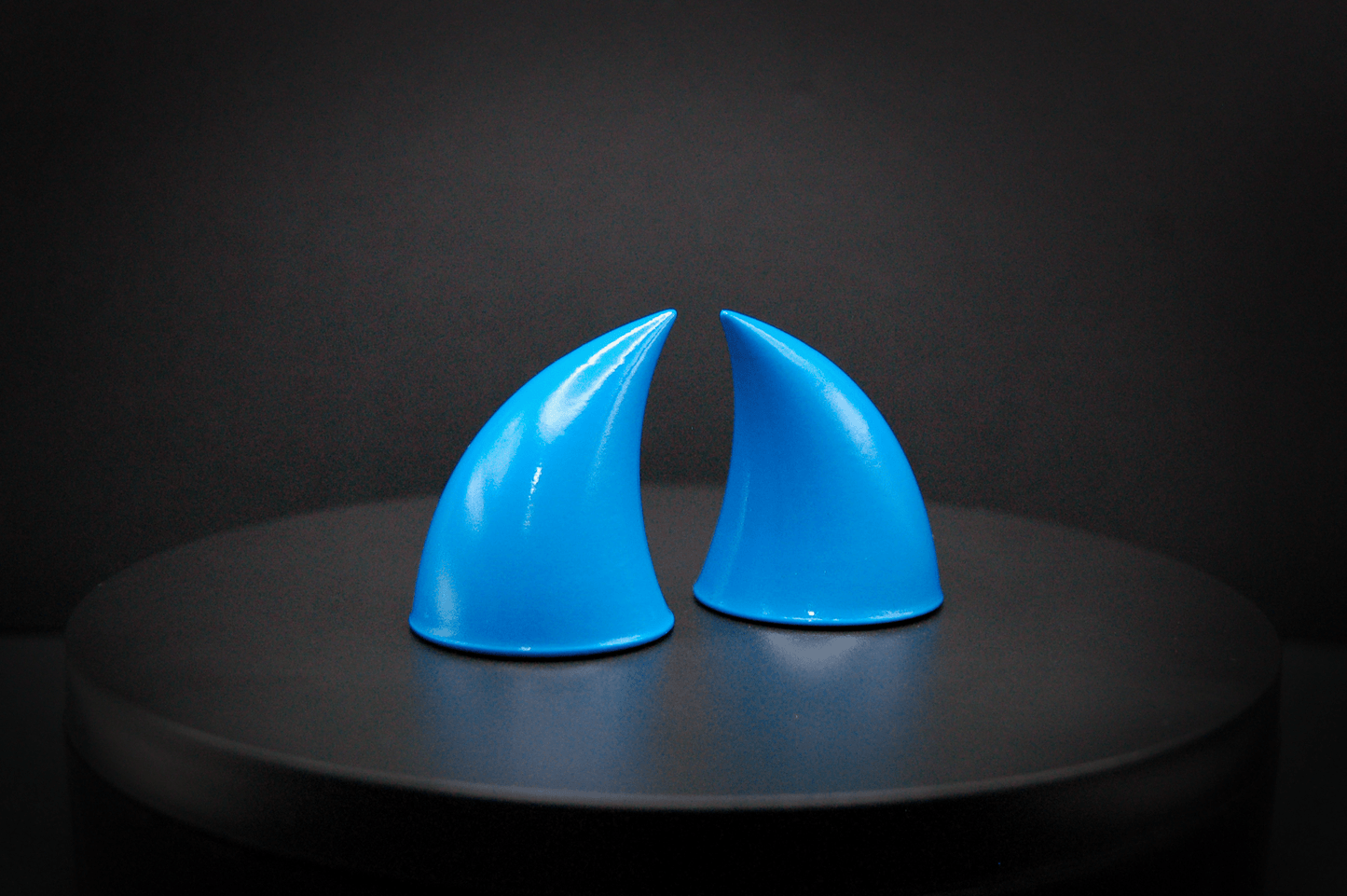 Side view of imp devil horns in nixie blue, a turquoise color with a glossy finish.