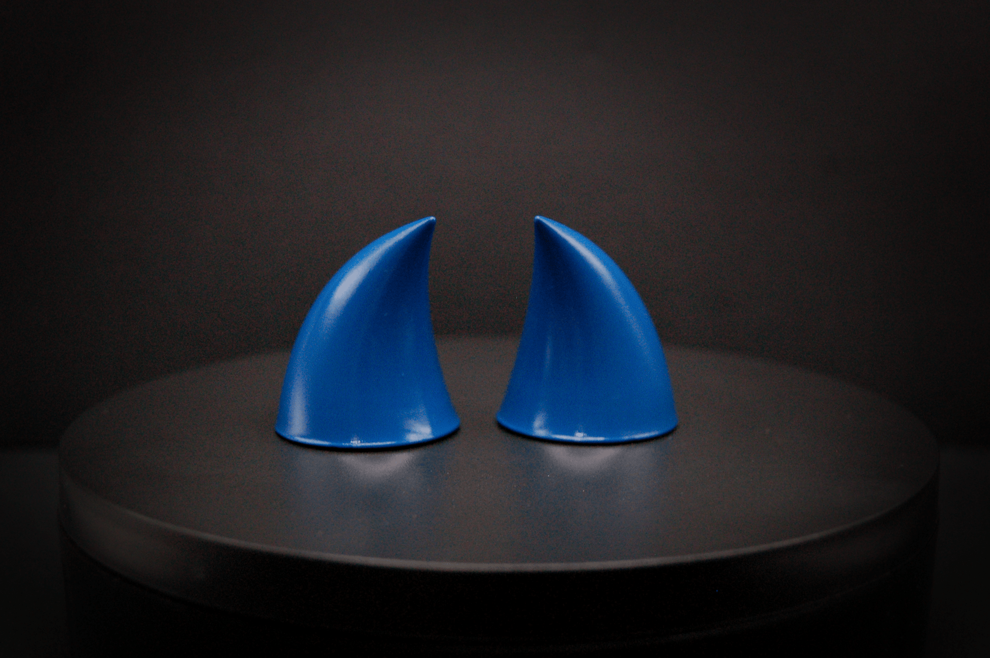 Back view of imp devil horns in storm blue, a deep blue with a glossy finish.