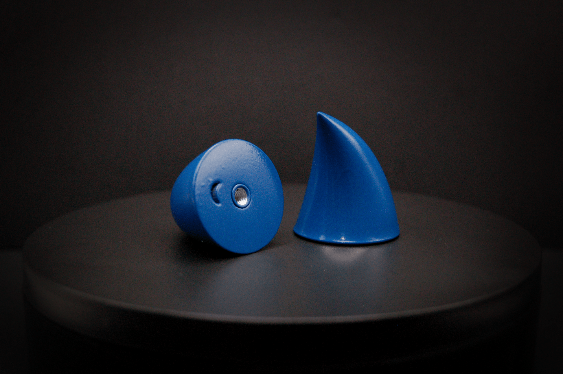 Bottom view of imp devil horns in storm blue, a deep blue with a glossy finish, showing a threaded insert on the base.